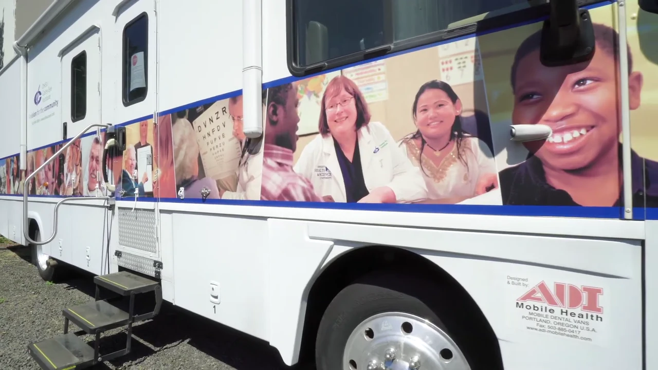 An ADI Mobile Health clinic vehicle is parked outdoors
